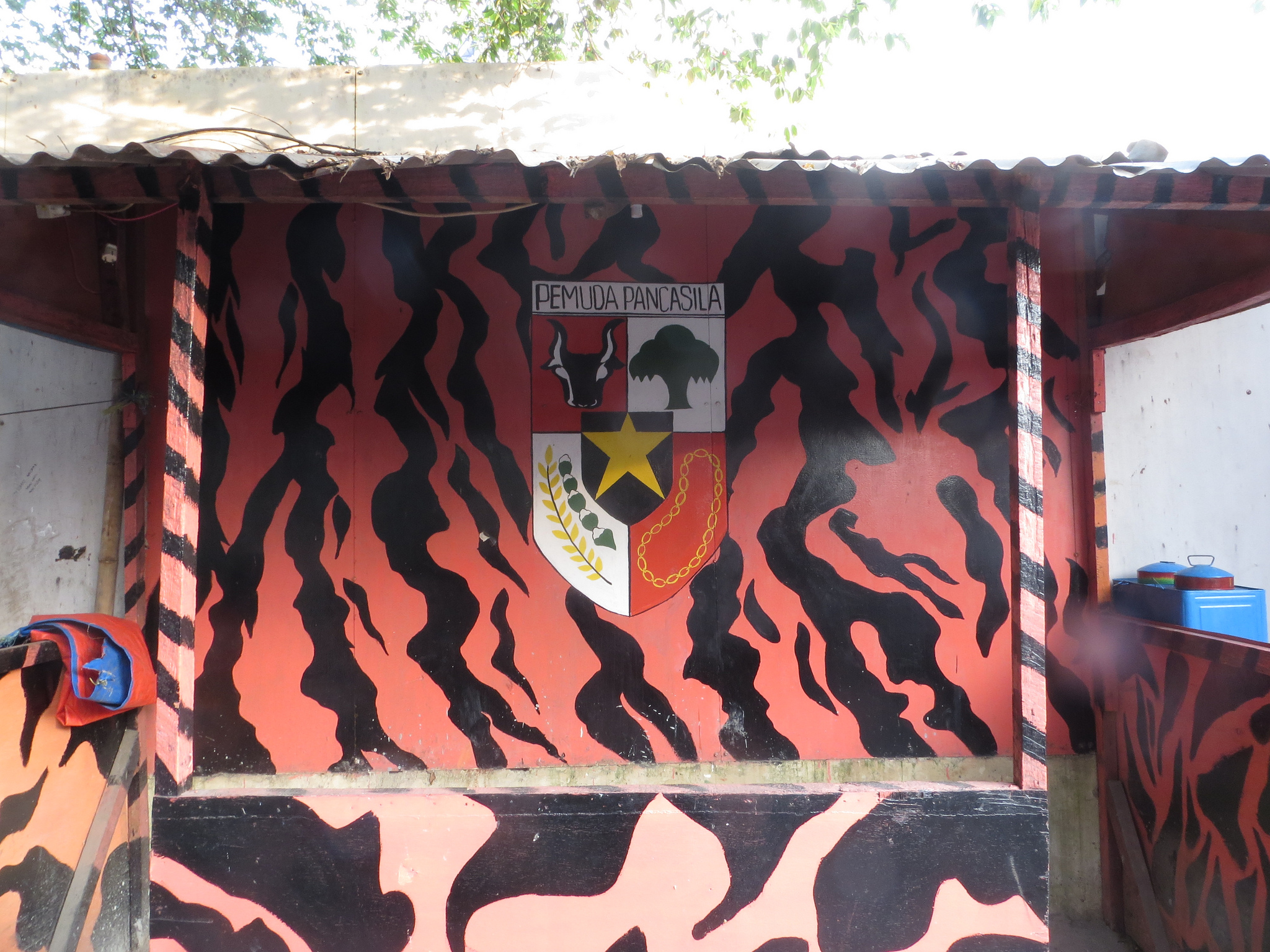 A coat-of-arms signifying Pemuda Pancasila painted at an ojek stop. (Don Meliton/Flickr)